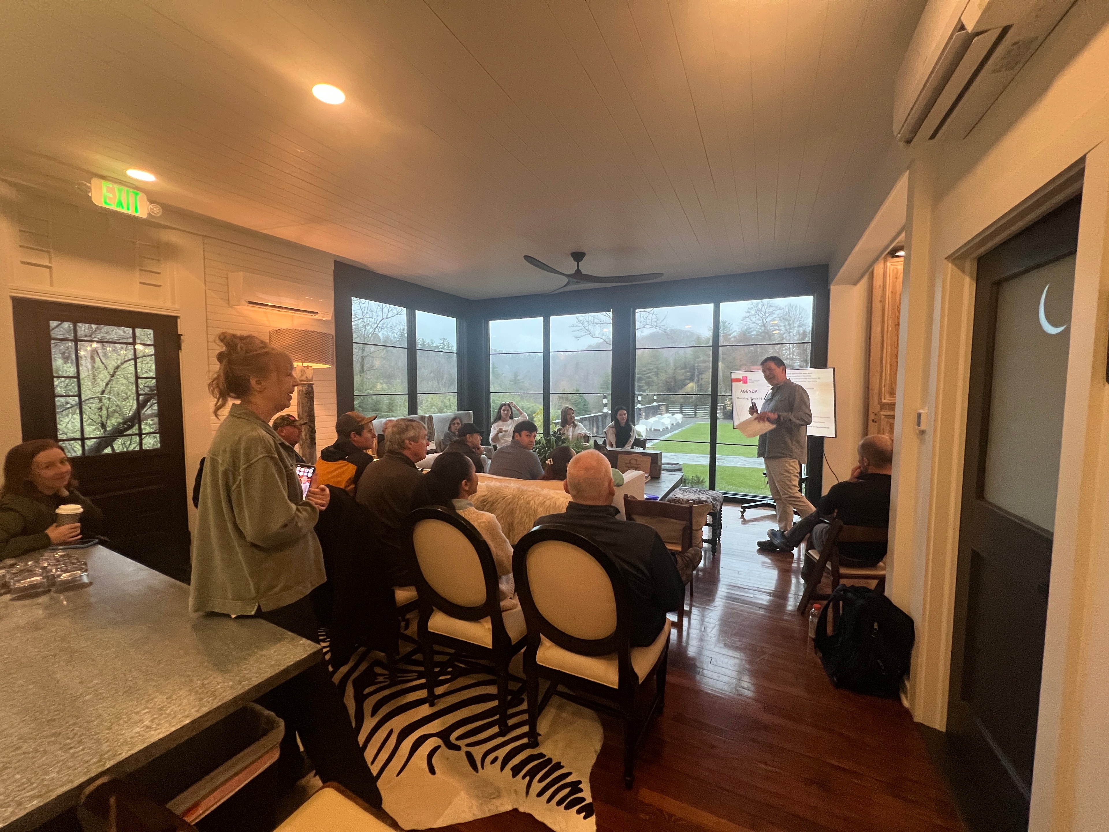 Corporate team meeting in The Saluda Inn sunroom with mountain views