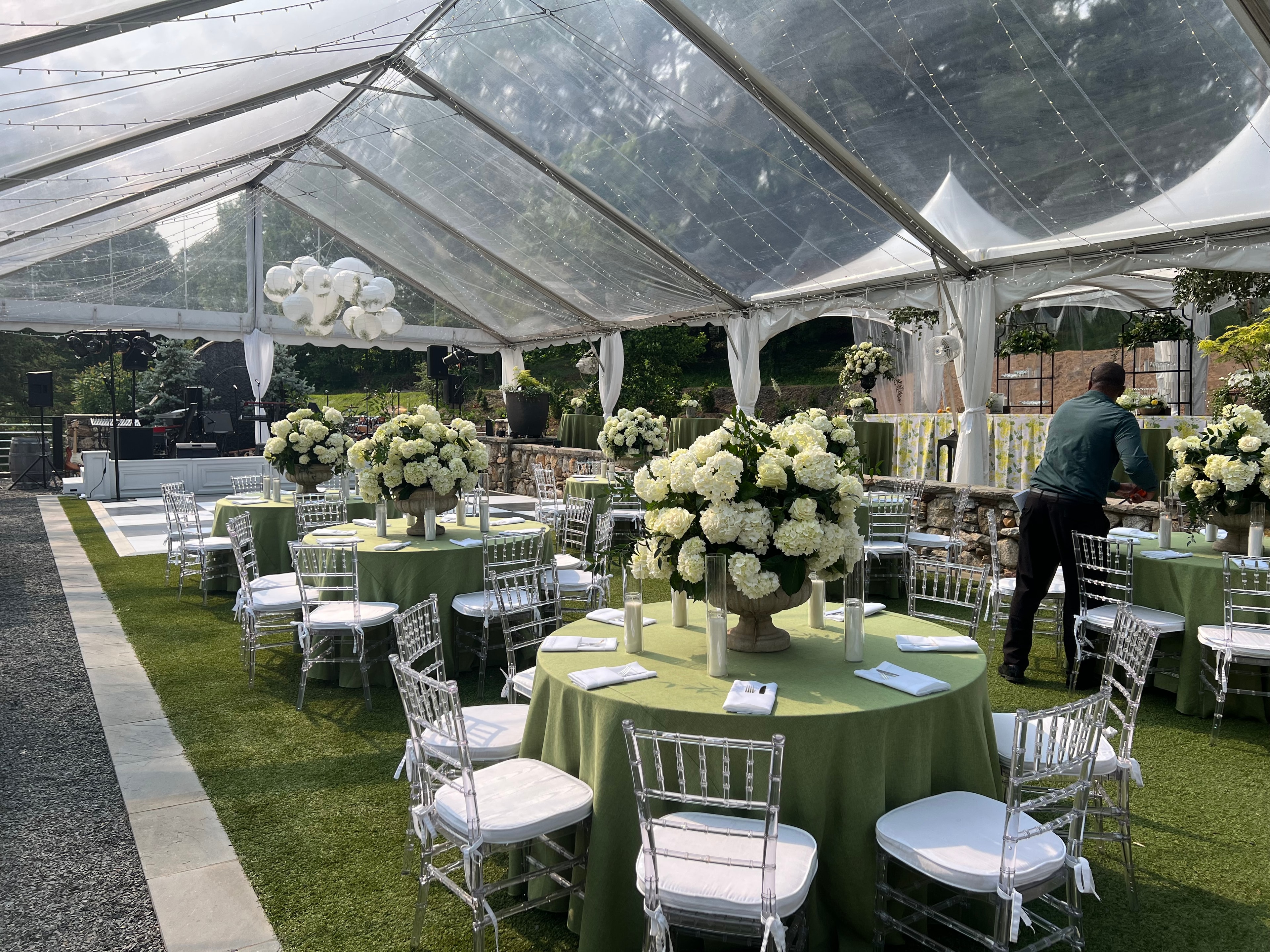 Cocktail hour under tent with string lights at The Saluda Inn, WNC wedding venue