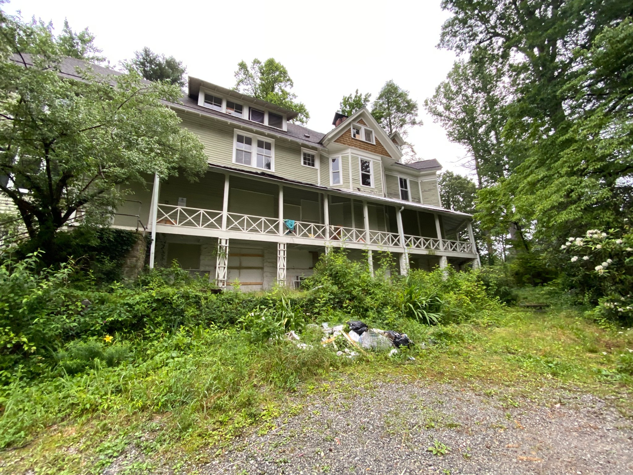 Wraparound porch — debris throughout