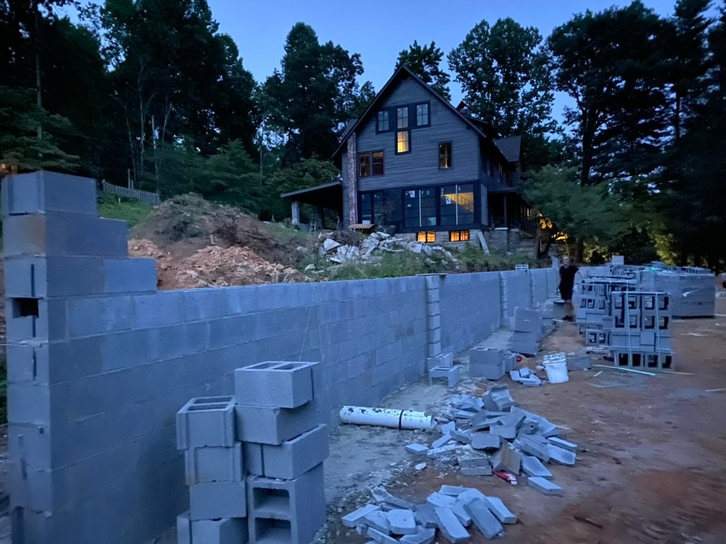 Terrace walls at twilight — inn glowing in the background
