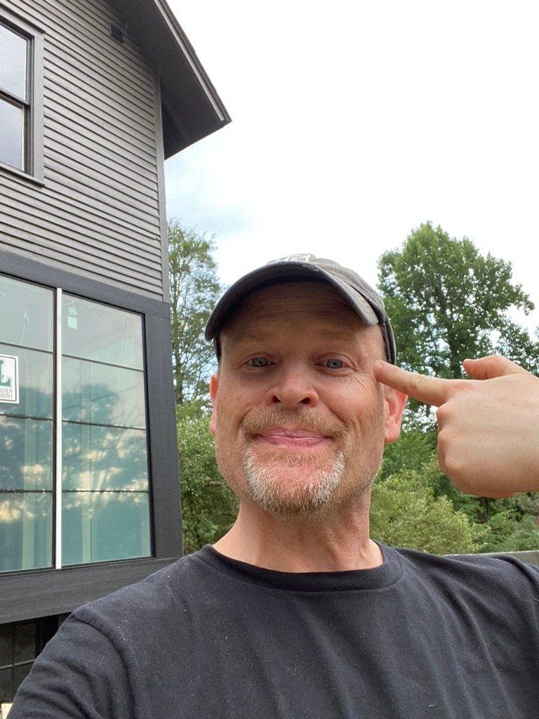 Jay on site — new addition siding & windows taking shape behind him