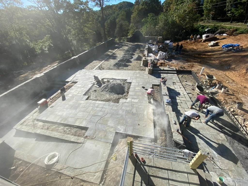 Bluestone installation — crew laying the Grand Lawn Terrace stone surface