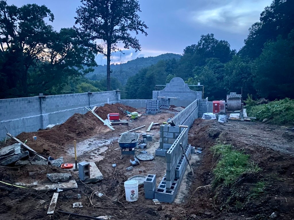 Grand Lawn Terrace at dusk — CMU walls rising with the mountain view beyond
