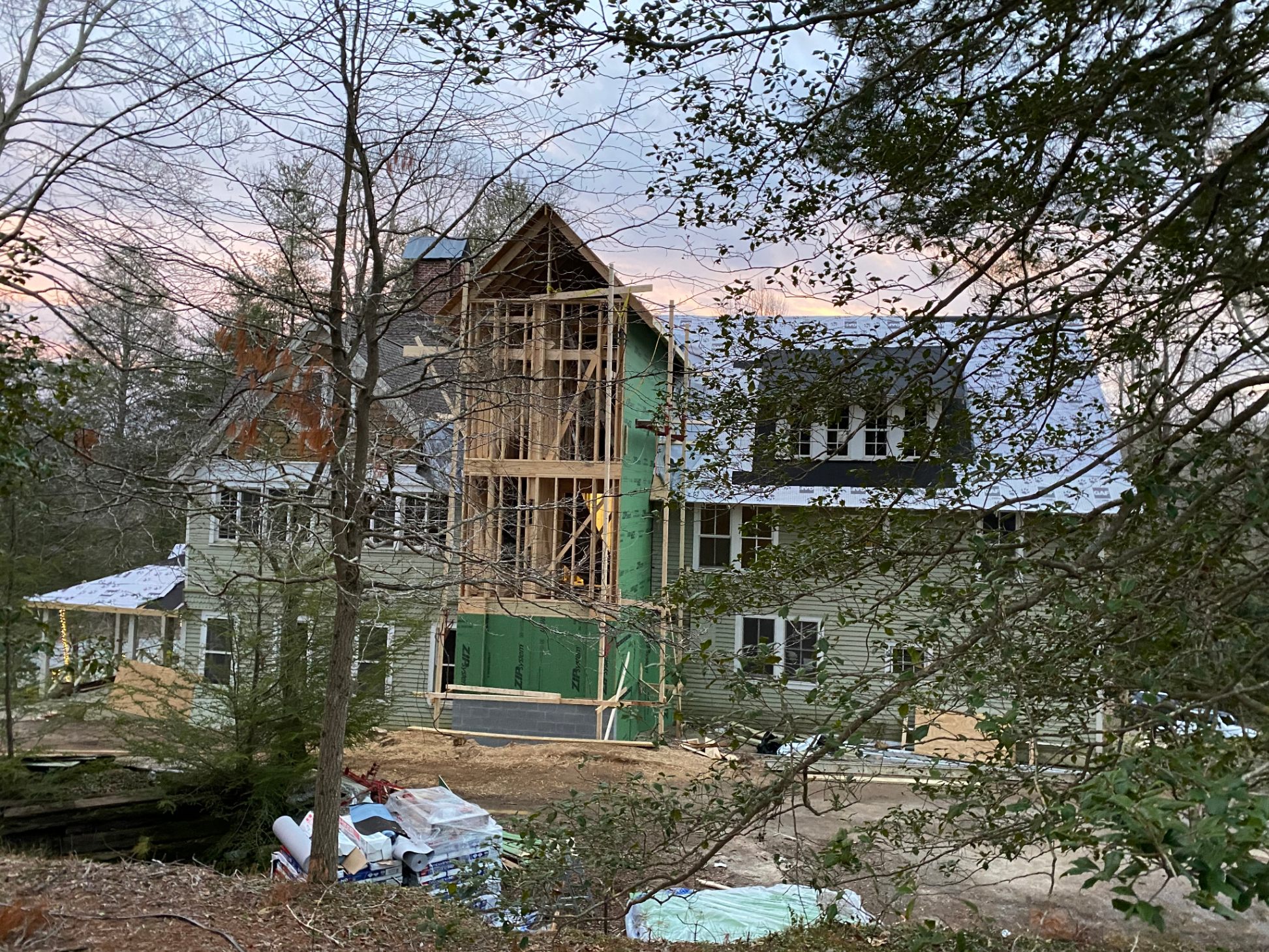 Exterior at dusk — addition framing & new roofline
